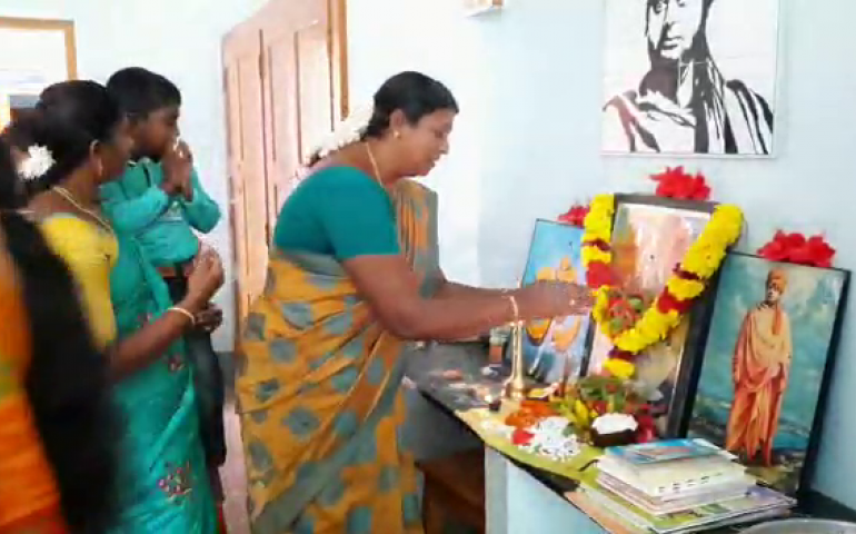 Teachers offering flowers to Goddess Saraswathi.