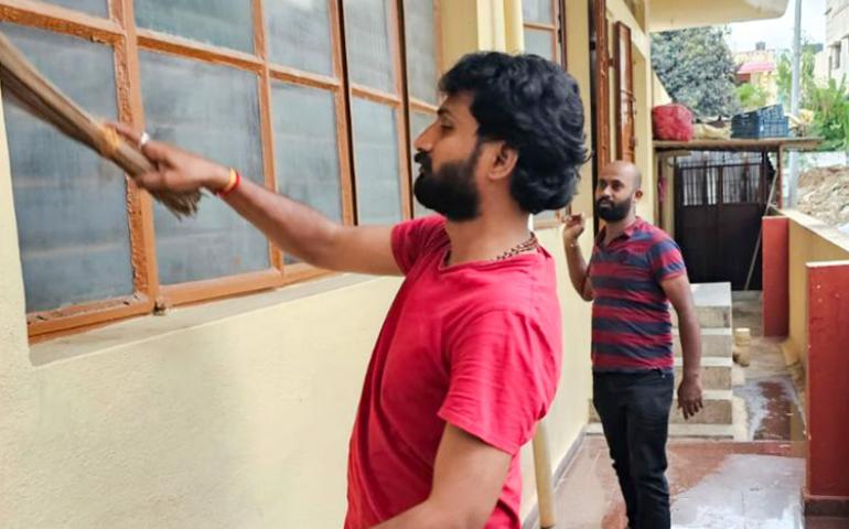Karyakarthas cleaning the temple premises