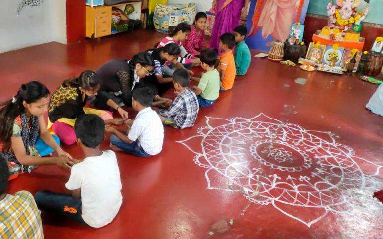 Samskarvarga students tying Rakhis